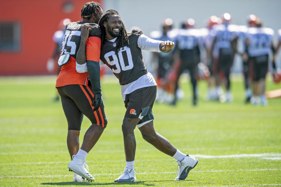 Cleveland Browns defensive linemen Jadeveon Clowney, right, goofs around with defensive linemen Myles Garrett (95) during an NFL football practice in Berea, Ohio, Wednesday, Aug. 4, 2021. (AP Photo/David Dermer)