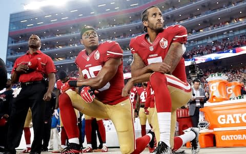 Colin Kaepernick (R) began the movement - Credit: AP