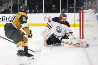 Vegas Golden Knights center Chandler Stephenson (20) scores a goal past Edmonton Oilers goaltender Mikko Koskinen (19) during the second period of an NHL hockey game Saturday, Nov. 27, 2021, in Las Vegas. (AP Photo/Chase Stevens)