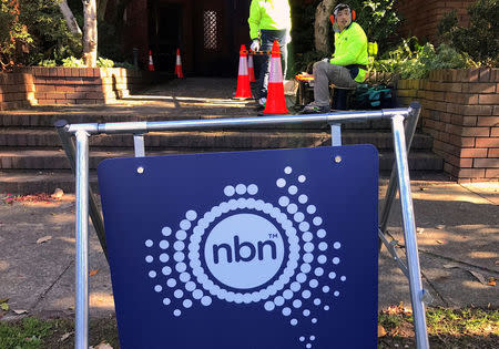 FILE PHOTO: Workers install cables for the Australian National Broadband Network (NBN) at an apartment block in Sydney, Australia, May 30, 2017. REUTERS/David Gray/File photo