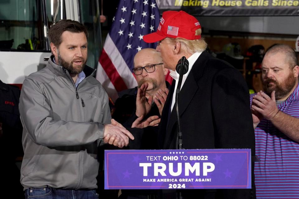 JD Vance shakes hands with Donald Trump in East Palestine, Ohio in 2023 (AP)