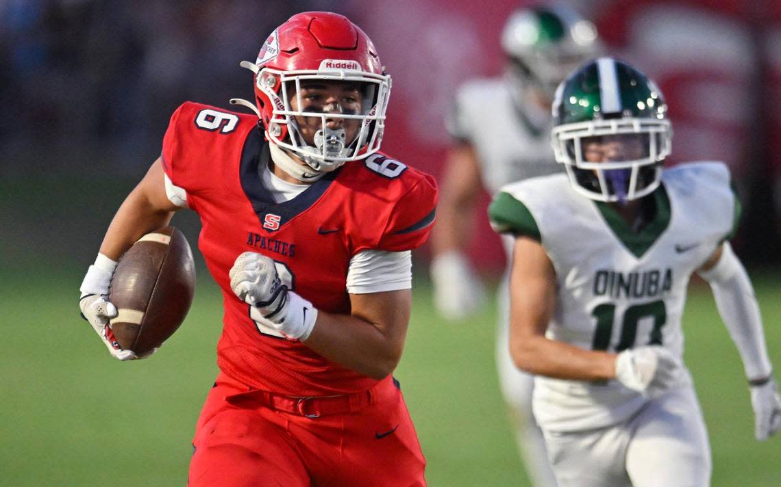 Sanger’s Conner Bohlken, left, runs for a touchdown against Dinuba Friday, Aug. 18, 2023 in Sanger. ERIC PAUL ZAMORA/ezamora@fresnobee.com