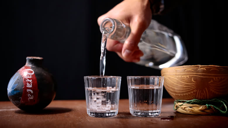 pouring tequila into glass