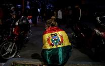 Members of Youth Resistance "Cochala" celebrate after Bolivian Senator Jeanine Anez became interim president in La Paz