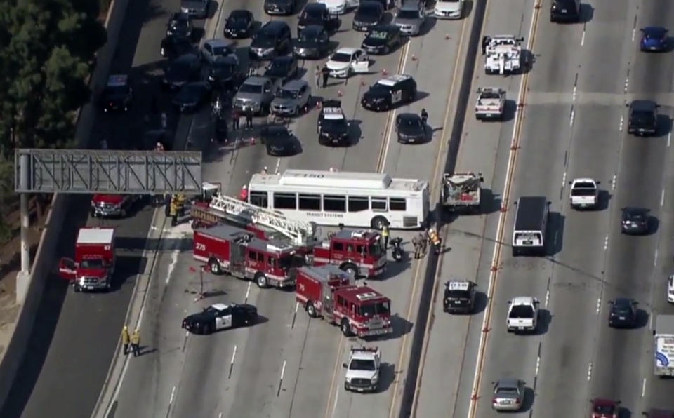 This aerial image made from video provided by KABC-TV shows the wreckage of a bus accident along Interstate 405 in Los Angeles on Sunday, Oct. 14, 2018. Authorities say at least 25 people were injured when the bus crashed into vehicles and through a concrete divider on the highway. (KABC-TV via AP)