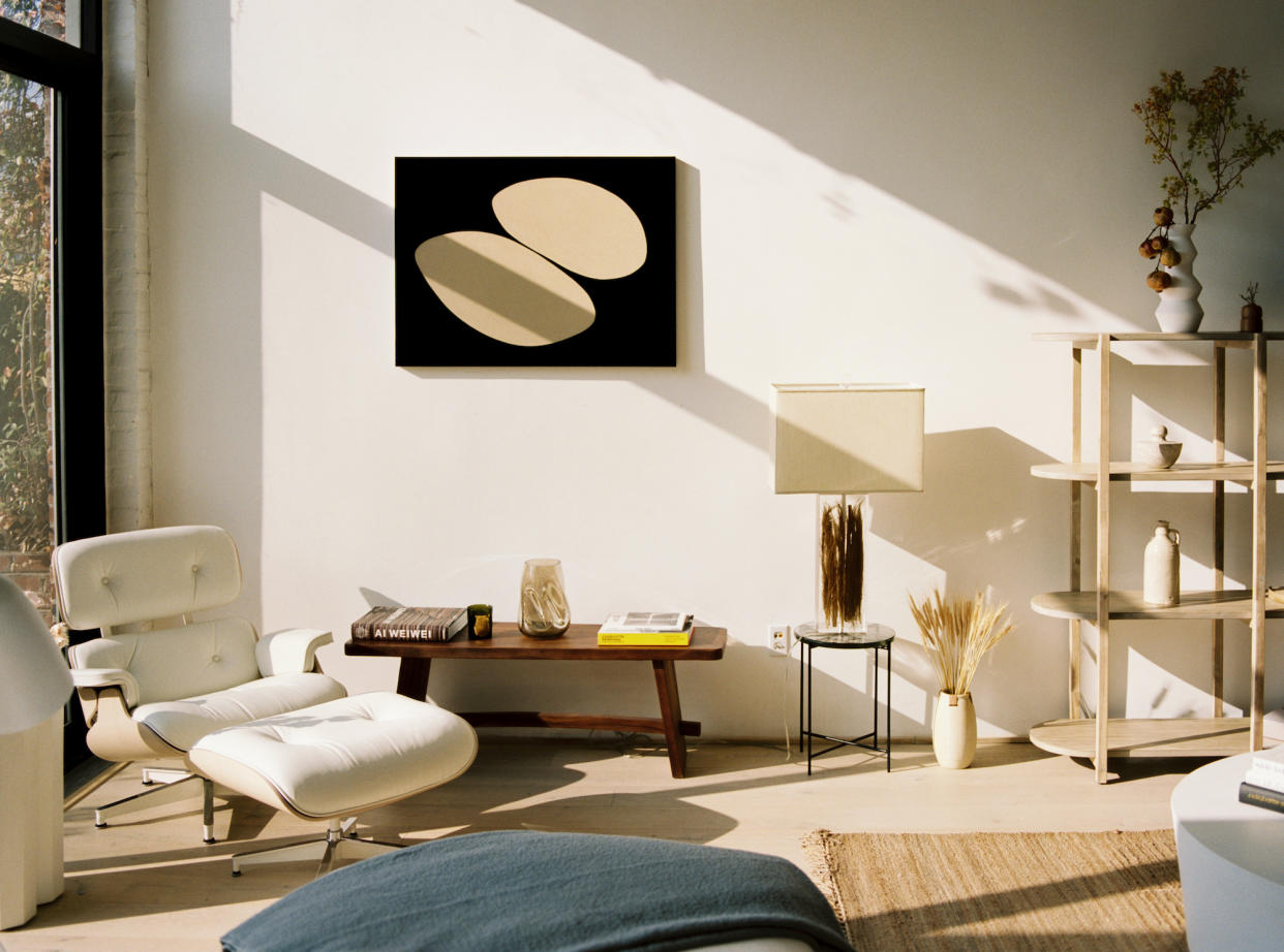  A Japandi style interior with a white Eames chair and a neutral color palette. 