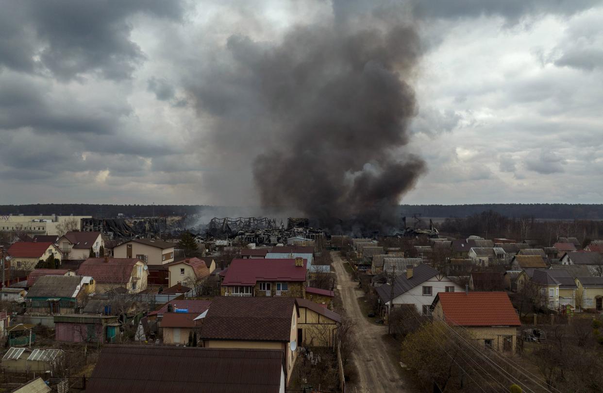 A factory and a store burn after being bombarded in Irpin, on the outskirts of Kyiv, Ukraine, Sunday, March 6, 2022.