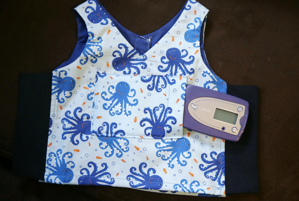 In this Feb. 3, 2014 photo, a digital audio recorder rests on a toddler's bib at a home in Providence, R.I. The city has begun an effort to boost language skills for children from low-income families by equipping them with audio recorders that count every word they hear. During home visits, social workers go over the word counts with parents and suggest tips to boost the child’s language skills. (AP Photo/Steven Senne)