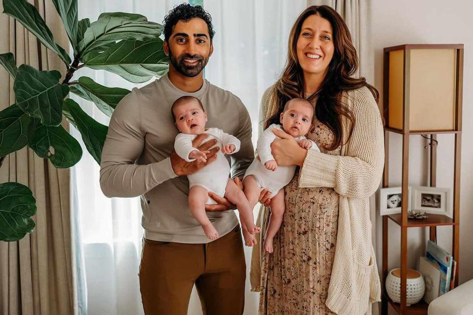 <p>Courtesy of Chinna Balachandran and Erica Wendel</p> Chinna Balachandran (left) holding daughter Maya with wife Erica Wendel holding daughter Anjali