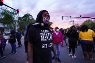 People stand in an intersection after at least one Pasquotank County Sheriff's deputy shot and killed a Black man, Andrew Brown Jr., while executing a search warrant, the sheriff's office said, Wednesday, April 21, 2021, in Elizabeth City, N.C. The deputy was wearing an active body camera at the time of the shooting, said Sheriff Tommy Wooten II, who declined to say how many shots the deputy fired or release any other details, citing a pending review by the State Bureau of Investigation. (AP Photo/Gerry Broome)