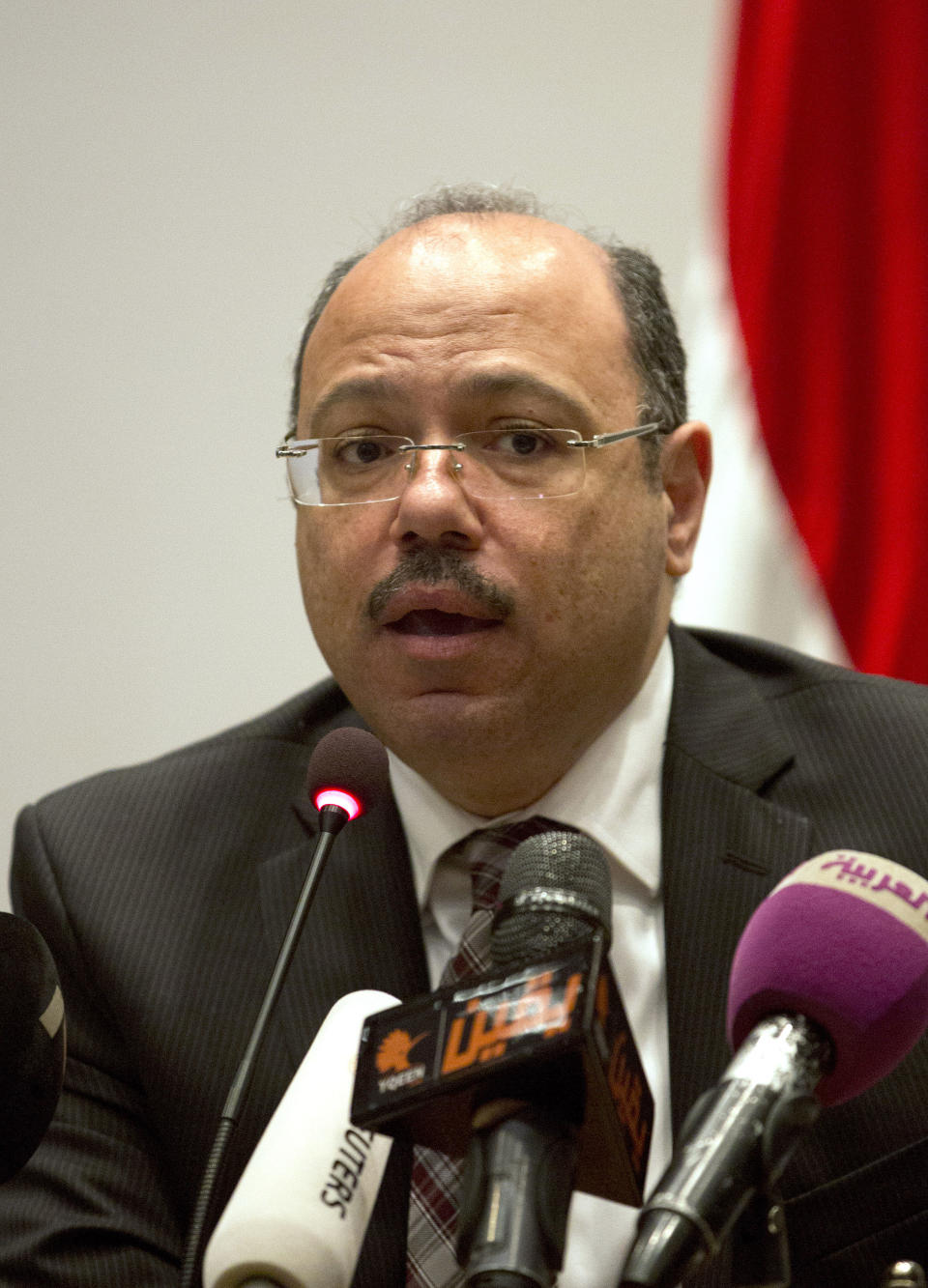 Egypt's Finance Minister, Hany Kadry Dimian, speaks to the media during a press conference in Cairo, Egypt Wednesday, March 12, 2014. Dimian says economic growth will remain at around 2 or 2.5 percent for 2013-14, rather than increase as his predecessor had predicted. Dimian also told reporters Wednesday that the budget deficit will stay high at 12 percent. Last year's deficit of 13.7 percent was a record high, while growth was an anemic 2.1 percent. (AP Photo/Khalil Hamra)