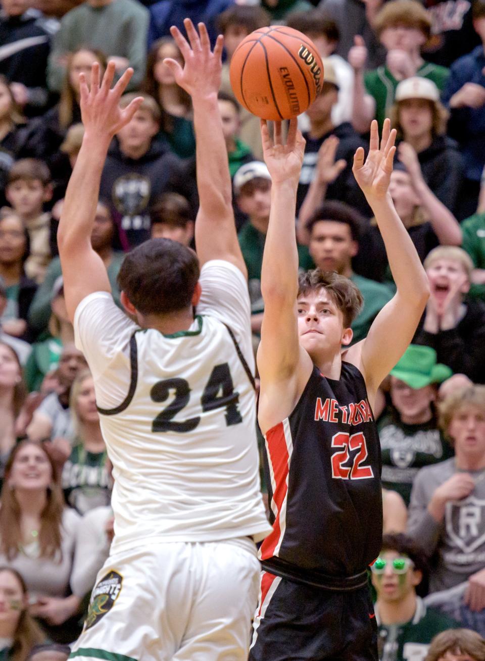 Metamora's Tyson Swanson, right, shoots over Richwoods' Sabri Qattum during their Class 3A sectional final Friday, March 3, 2023 at Galesburg High School. The Redbirds defeated the Knights 65-60.