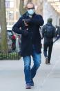 <p>David Harbour points to his shoulder where he got his vaccine shot after leaving N.Y.C.'s Javits Center on Wednesday.</p>