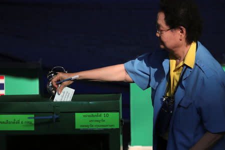 A voter casts their ballot as they vote at a polling station during the general election in Bangkok, Thailand, March 24, 2019. REUTERS/Athit Perawongmetha