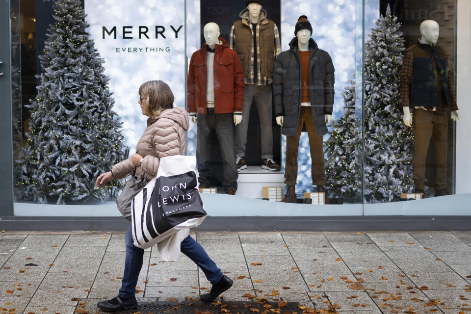 CARDIFF, WALES - OCTOBER 21: A woman carrying a shopping bag walks past a Next store on October 21, 2022 in Cardiff, United Kingdom. The Office For National Statistics announced that September's retail sales volumes have fallen by 1.4% much more than expected as households cut back spending in the face of rising borrowing and energy costs. The mourning period following Queen Elizabeth II's death was also considered a factor. Meanwhile, public sector borrowing hit £20 billion in September, compared with the £17.1 billion forecast. (Photo by Matthew Horwood/Getty Images)