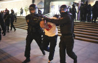 Riot police detain a protester during an opposition rally to protest the presidential inauguration in Minsk, Belarus, Wednesday, Sept. 23, 2020. Belarus President Alexander Lukashenko has been sworn in to his sixth term in office at an inaugural ceremony that was not announced in advance amid weeks of huge protests saying the authoritarian leader's reelection was rigged. Hundreds took to the streets in several cities in the evening to protest the inauguration. (AP Photo/TUT.by)