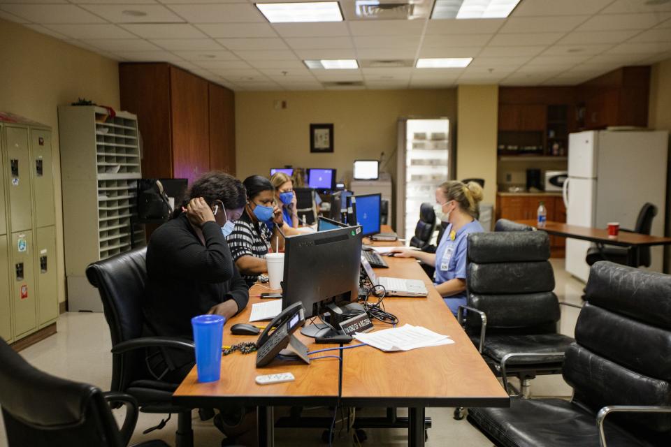 Medical staff at Tallahassee Memorial HealthCare work at computers in the command center where patients are prioritized and placed on the proper floor based on their conditions and symptoms Monday, Aug. 23, 2021. Staff who work in the command center also ensure that the COVID floors are fully staffed at least two weeks in advance.