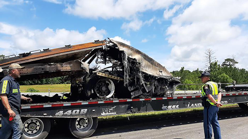 FILE - Some of the wreckage from a fatal multiple-vehicle crash a day earlier is loaded to be carried away, June 20, 2021, in Butler County, Ala. A crash that killed 10 people — including nine children — on a rain-slicked Alabama interstate happened after a tractor-trailer truck slammed into vehicles that had slowed down because of minor crashes, according to a preliminary report released Tuesday, Aug. 3, 2021. (Lawrence Specker/Press-Register/AL.com via AP)