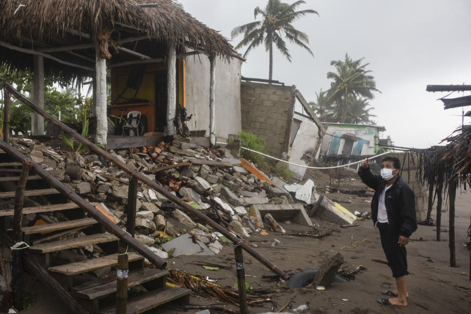 A man inspects the damage after a part of his home was toppled by winds brought on by Hurricane Grace, in Tecolutla, Veracruz State, Mexico, Saturday, Aug. 21, 2021. Grace hit Mexico’s Gulf shore as a major Category 3 storm before weakening on Saturday, drenching coastal and inland areas in its second landfall in the country in two days. (AP Photo/Felix Marquez)