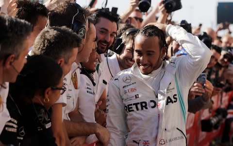 Lewis Hamilton celebrates his sixth world title - Credit: AP