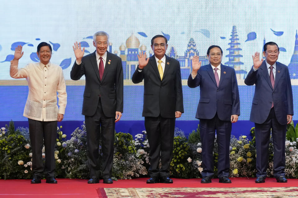 From left to right; Philippine's President Ferdinand Marcos, Jr., Singapore's Prime Minister Lee Hsien Loong, Thailand's Prime Minister Prayuth Chan-ocha, Vietnam's Prime Minister Pham Minh Chinh, Cambodia Prime Minister Hun Sen wave during the opening ceremony of the 40th and 41st ASEAN Summits (Association of Southeast Asian Nations) in Phnom Penh, Cambodia, Friday, Nov. 11, 2022. (AP Photo/Vincent Thian)