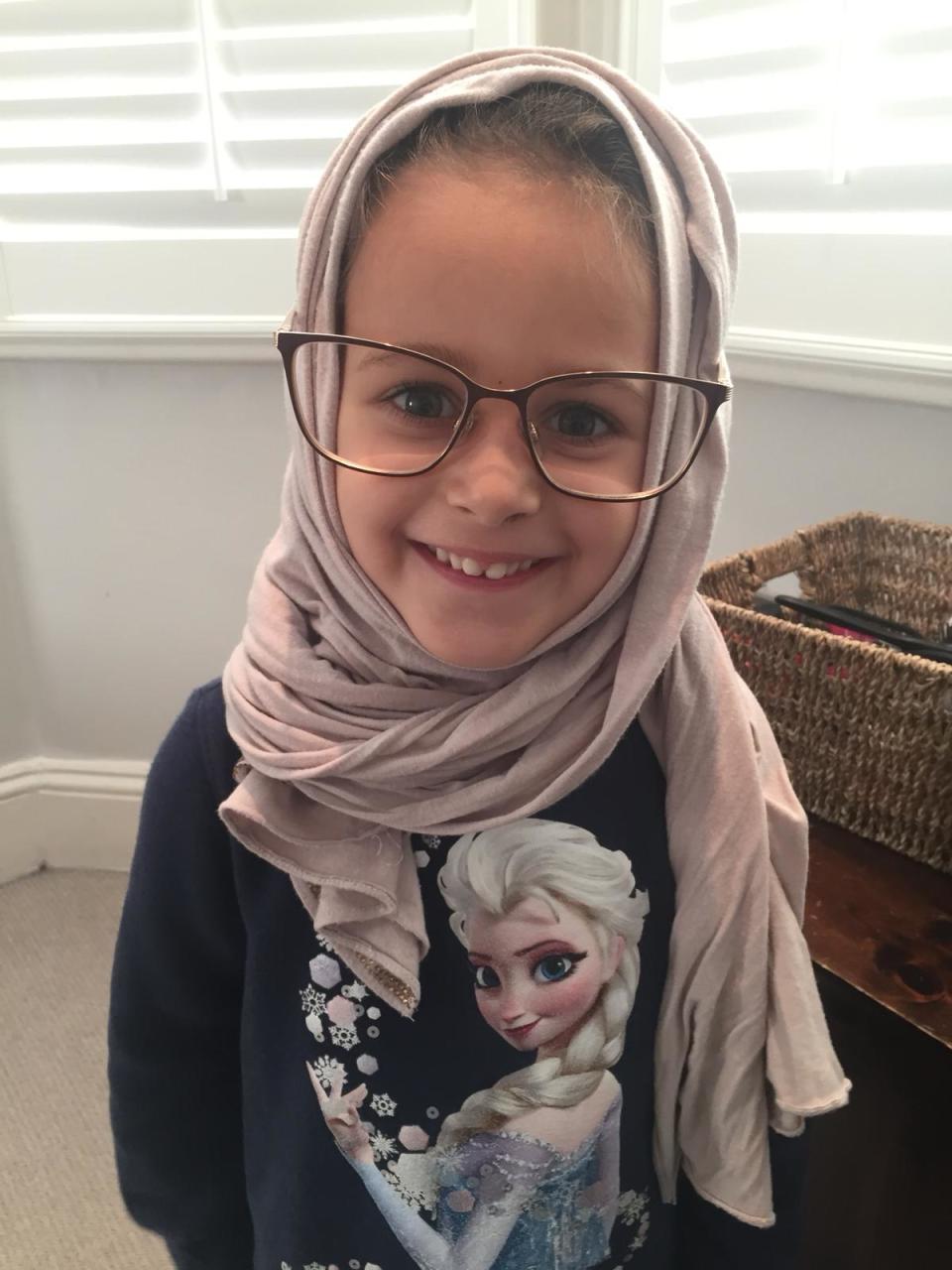 Marley tries on the headscarf of her nanny Leyla Ridha (Tara Grossman )