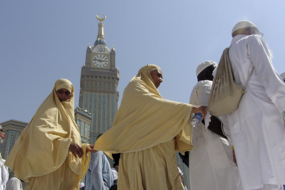 The tallest clock tower in the world with the world's largest clock face, atop the Abraj Al-Bait Towers, overshadows Muslim pilgrims as they circumambulate around the Kaaba, the cubic building at the Grand Mosque, in the Muslim holy city of Mecca, Saudi Arabia, Monday, Aug. 5, 2019. (AP Photo/Amr Nabil)