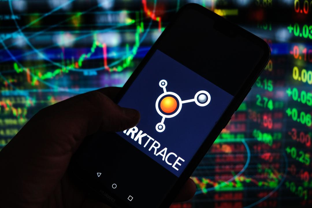In this photo illustration a Darktrace logo seen displayed on a smartphone with stock market percentages in the background. (Photo by Omar Marques / SOPA Images/Sipa USA)