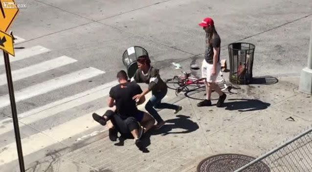 An onlooker records the moment three people are caught in a Manhattan street brawl in what appears to be a road rage incident. Source: LiveLeak