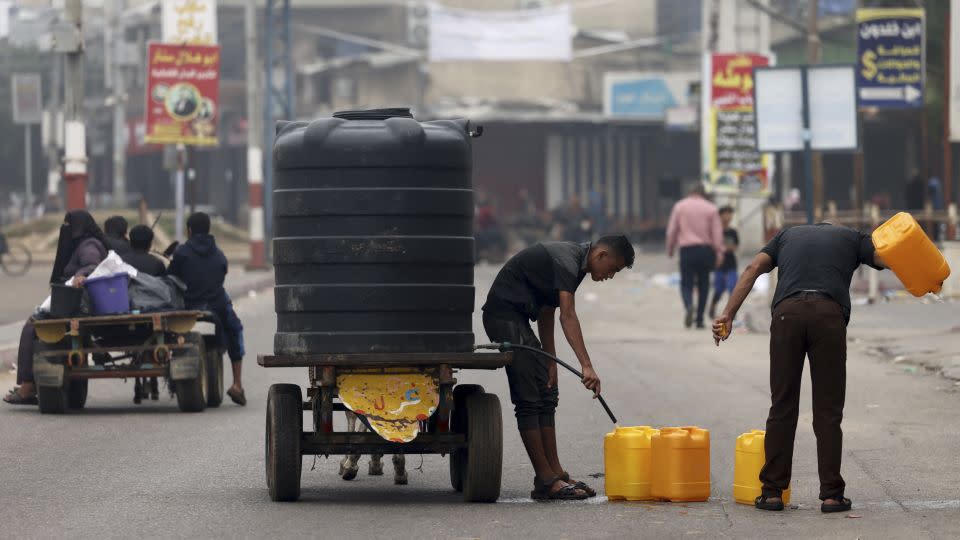 People fill plastic containers with potable water in Rafah, in the southern Gaza Strip on October 23, 2023. - Mohammed Abed/AFP/Getty Images