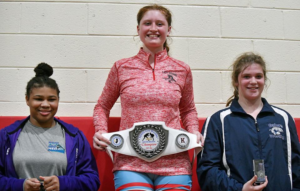 Pennsauken's Hannah Dahl, center, holds her championship belt after defeating Gateway's Shaelie Young 2-1 following Saturday's 185 lb. bout at the NJSIAA 2022 South Region girls' wrestling tournament held at Kingsway High School. Feb. 12, 2022.