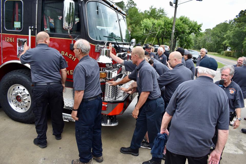 Members of the Calabash Fire Department participate in a "push-in" ceremony for the department's new ladder truck on May 27, 2022, in Calabash.