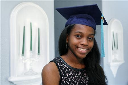 Grace Bush poses in her university graduation cap at her home in West Park, Florida, May 6, 2014. REUTERS/Andrew Innerarity