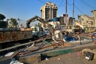 Security forces remove anti-government protesters tents at protesters' site in Tahrir Square, Baghdad, Iraq, Saturday, Oct. 31, 2020. (AP Photo/Khalid Mohammed)