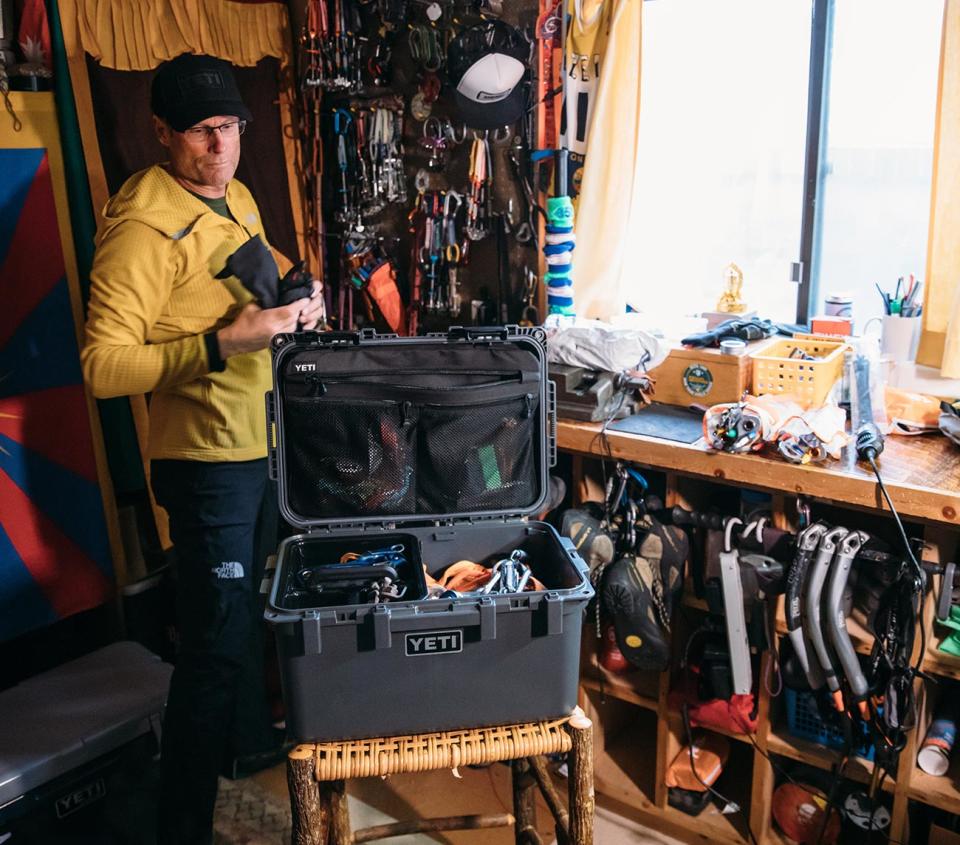 Man packing a Yeti GoBox with gear