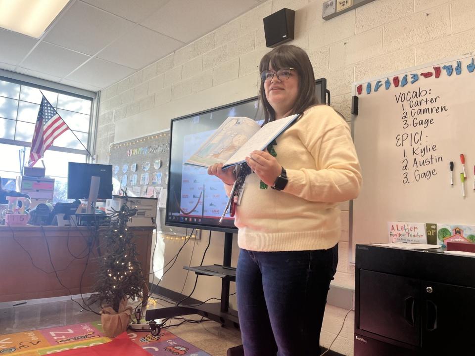 Amber Brennan, fourth grade teacher at Eyler Elementary School, introduces "A Book Full of Kindness," a book published by students in her class, during a classroom publishing party.