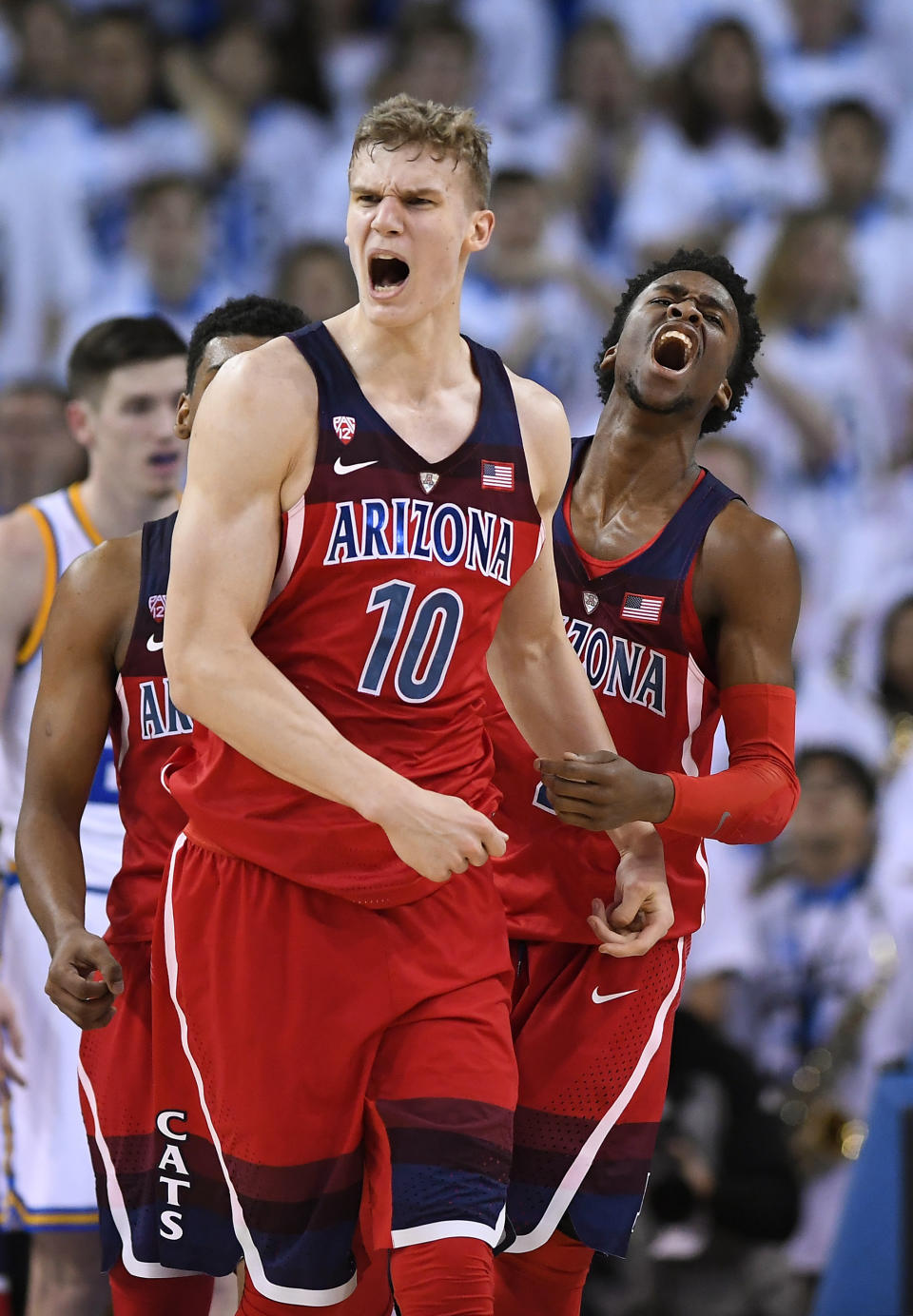 Arizona forward Lauri Markkanen, left, and guard Kobi Simmons celebrate after they scored late in the second half of an NCAA college basketball game against UCLA, Saturday, Jan. 21, 2017, in Los Angeles. Arizona won 96-85. (AP Photo/Mark J. Terrill)