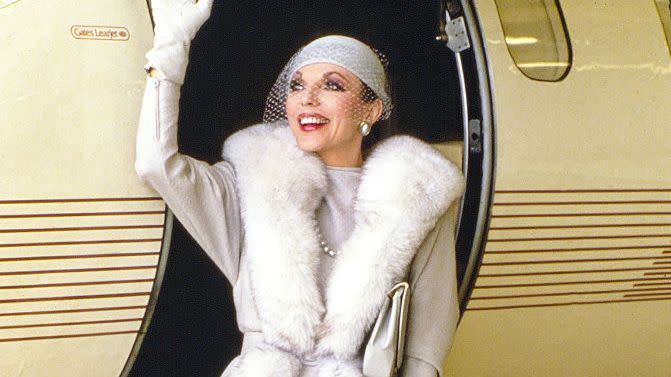 actress joan collins during filming of tv series dynasty at van nuys airport, california in june 1986