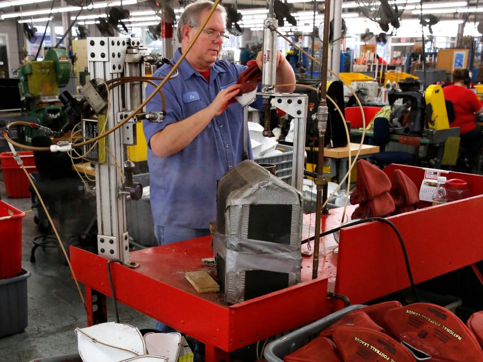 Jim Gatchell turns an NFL Super Bowl LI football right side out at the Wilson Sporting Goods factory in Ada, Ohio. In one of the most physical jobs at the plant, the ball is first placed into a container where it is steamed and then reversed with the use of a steel bar.