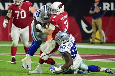 Sep 25, 2017; Glendale, AZ, USA; Arizona Cardinals quarterback Carson Palmer (3) is tackled by Dallas Cowboys defensive end DeMarcus Lawrence (90) and defensive tackle Maliek Collins (96) during the second half at University of Phoenix Stadium. Mandatory Credit: Matt Kartozian-USA TODAY Sports