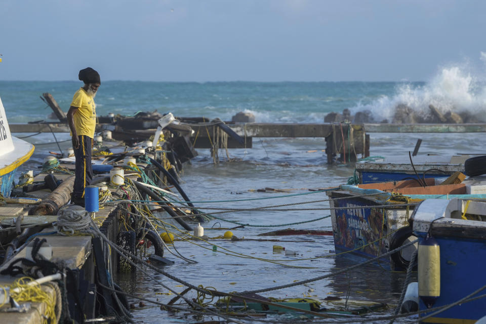 A fisherman looks out at vessels damaged by Hurricane Beryl at the Bridgetown Fisheries in Barbados, Monday, July 1, 2024. (AP Photo/Ricardo Mazalan)