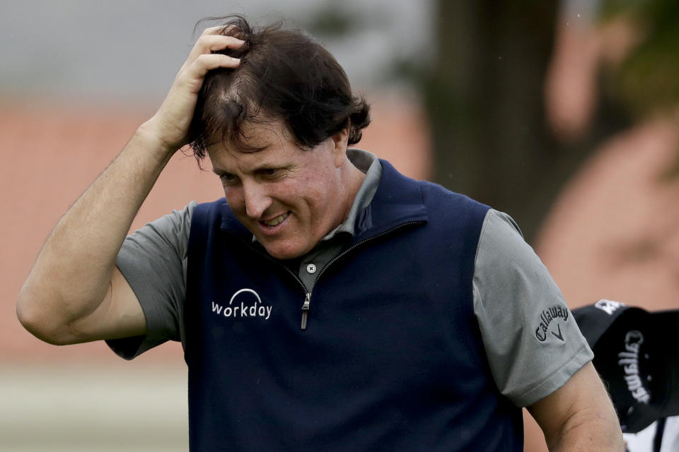 Phil Mickelson heads off the green after shooting 12-under-par 60 in the first round of the Desert Classic golf tournament at La Quinta Country Club on Thursday, Jan. 17, 2019, in La Quinta, Calif. (AP Photo/Chris Carlson)