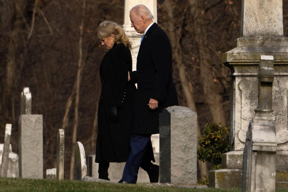 President Joe Biden and first lady Jill Biden walk between tombstones to attend Mass at St. Joseph on the Brandywine Catholic Church in Wilmington, De., on . Sunday marks the 50th death anniversary of President Biden's first wife, Neilia Hunter Biden and their daughter Naomi Biden,