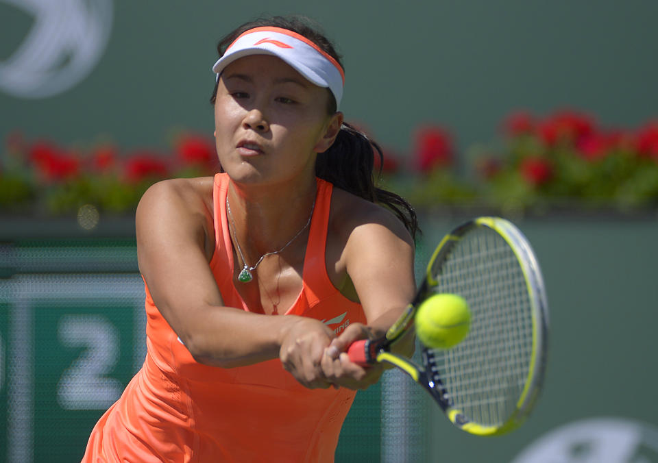 Peng Shuai, of China, returns a shot against Vera Zvonareva, of Russia, during a first round match at the BNP Paribas Open tennis tournament, Wednesday, March 5, 2014, in Indian Wells, Calif. (AP Photo/Mark J. Terrill)