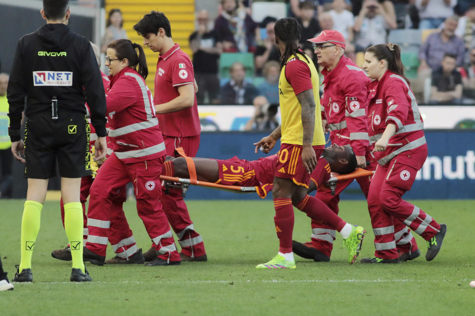 Roma's Evan Ndicka is carried off the pitch on a stretcher during the Serie A soccer match between Udinese and Roma at the Bluenergy Stadium in Udine, Italy, Sunday, April 14, 2024. (Andrea Bressanutti/LaPresse via AP)