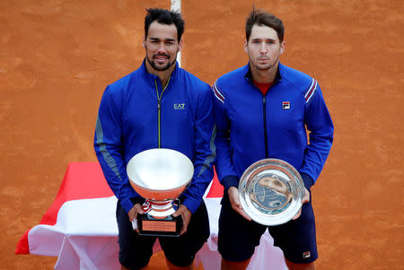 Tennis - ATP 1000 - Monte Carlo Masters - Monte-Carlo Country Club, Roquebrune-Cap-Martin, France - April 21, 2019 Italy's Fabio Fognini poses with Serbia's Dusan Lajovic as they pose with the winner and runner up trophies after the final REUTERS/Jean-Paul Pelissier