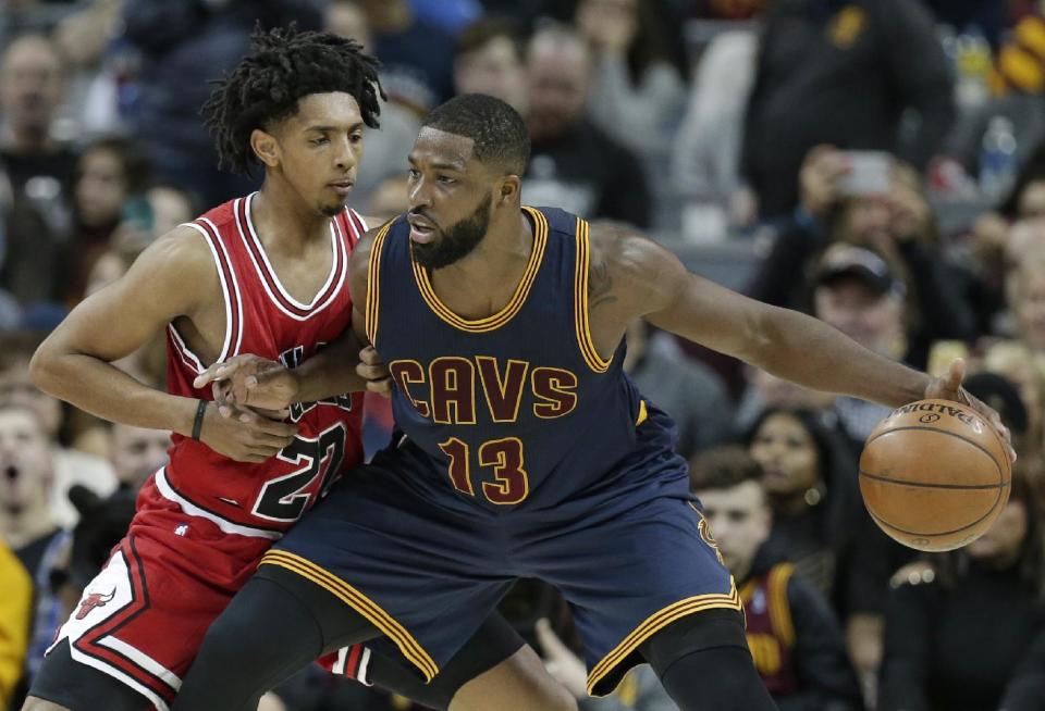 Cleveland Cavaliers' Tristan Thompson, right, drives past Chicago Bulls' Cameron Payne in the first half of an NBA basketball game, Saturday, Feb. 25, 2017, in Cleveland. (AP Photo/Tony Dejak)