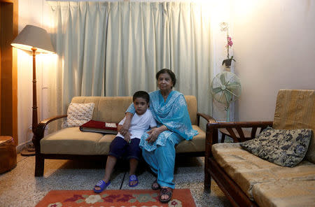 Rehana Khursheed Hashmi, 75, migrated from India with her family in 1960 and whose relatives, live in India, sits with her five year-old grandson Faraz Hashmi, at her residence in Karachi, Pakistan August 7, 2017. REUTERS/Akhtar Soomro