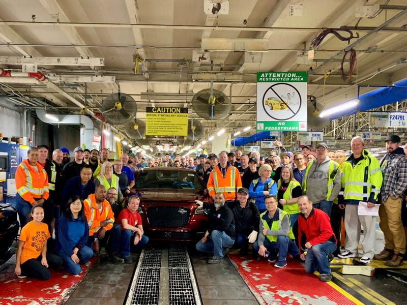 The final Chrysler 300C rolling off the production line with lots of employees celebrating