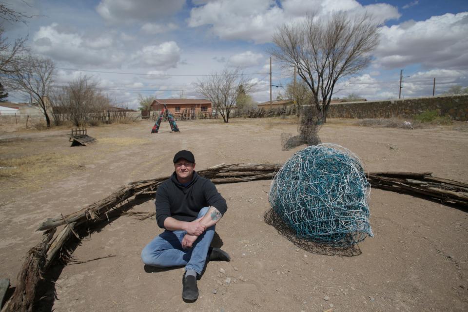 Brian Anthony Holt is shown March 24, 2021, with a wire sculpture he created.